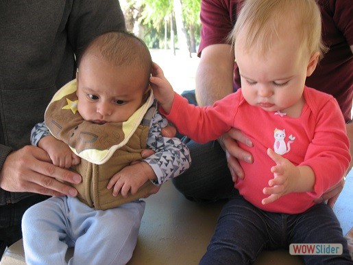 two babies are sitting together